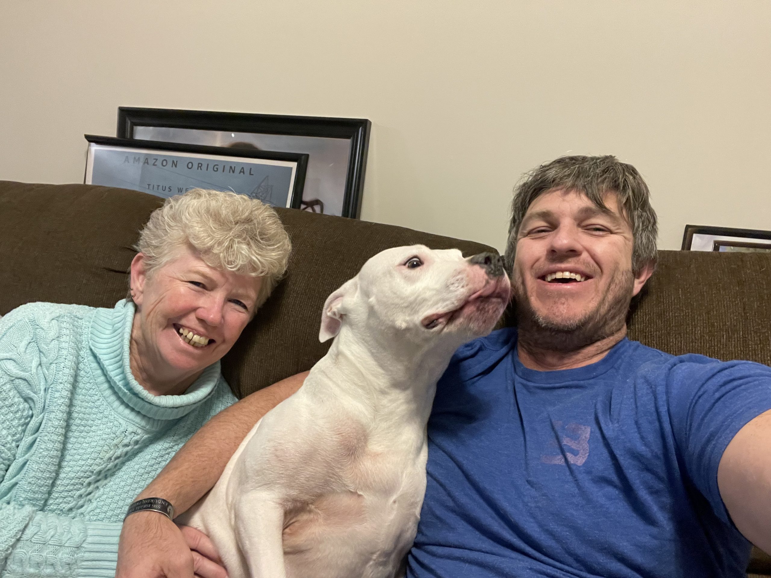 Chris and Joan sandwiching the beloved Staffie, Mia as she tries kissing Chris.